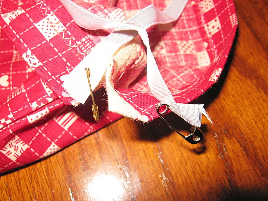 11 Attach safety pins to casing and to one end of cord